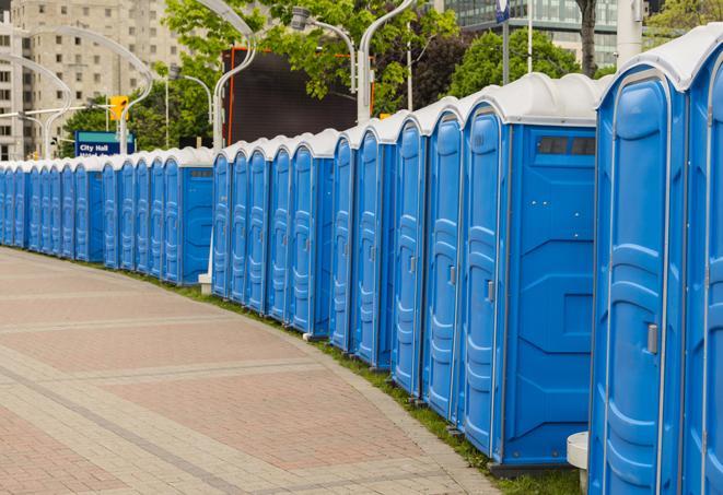 a row of portable restrooms set up for a special event, providing guests with a comfortable and sanitary option in Four Oaks